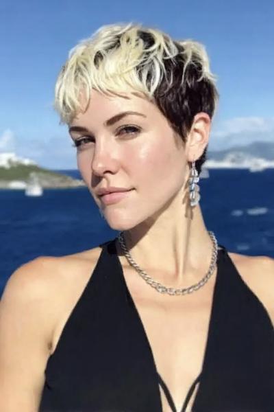Een vrouw met een kort kapsel met donkere haren aan de zijkanten en achterkant, en lichtblonde lokken bovenop.