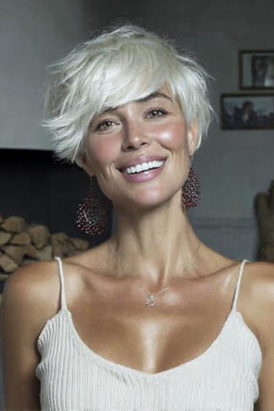 Een vrouw met kort, stijl blond haar in een warrig kapsel met een zijscheiding.